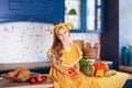 Little girl sits on table in kitchen holds big pumpkin. Harvesting. Healthy nutrition, vegetarianism, vitamins, vegetables. Cute c