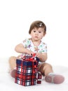 Little girl sits with three gift boxes Royalty Free Stock Photo