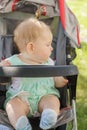 Little girl sitting in a baby carriage