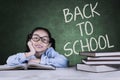 Little girl sitting with back to school word Royalty Free Stock Photo