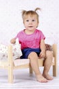 Little girl sitting on the bed Royalty Free Stock Photo