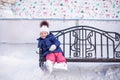 Little girl sitting on a bench in the skating rink Royalty Free Stock Photo