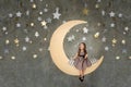 Little girl in sitting on big moon. Little girl dreaming Royalty Free Stock Photo