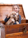 Little girl sitting in a box with a dog ang showing yes sign Royalty Free Stock Photo