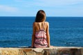 Little girl sitting at cliff at ocean front in Los Cabos Mexico resort cliff sea Royalty Free Stock Photo