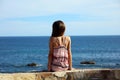 Little girl sitting at cliff at ocean front in Los Cabos Mexico resort cliff sea Royalty Free Stock Photo