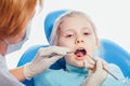 Little girl sitting in the dentists office Royalty Free Stock Photo