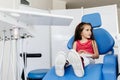 Little girl sitting in the dentists office Royalty Free Stock Photo