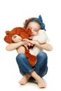 Little girl sitting on the floor and holding a teddy bear Royalty Free Stock Photo