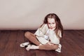 Little girl sitting on the floor and sad Royalty Free Stock Photo