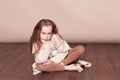 Little girl sitting on the floor and sad Royalty Free Stock Photo