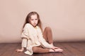 Little girl sitting on the floor and sad Royalty Free Stock Photo