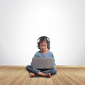 Little girl sitting on the floor with using laptop computer Royalty Free Stock Photo