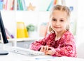 Little girl sitting in front of computer