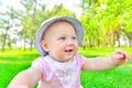 Little girl sitting on green grass, close up Royalty Free Stock Photo