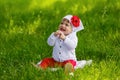 Little girl sitting on green grass Royalty Free Stock Photo