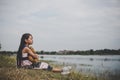 Little girl sitting with her bear upset at meadows field.