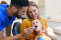 Little girl sitting with her mother on a dentists chair during dentist examination. Royalty Free Stock Photo