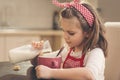 Girl pouring milk into a cereal cup Royalty Free Stock Photo