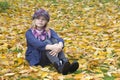 Little girl sitting on leaves Royalty Free Stock Photo