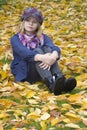 Little girl sitting on leaves Royalty Free Stock Photo