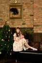 Little girl sitting near Christmas tree Royalty Free Stock Photo