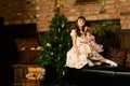 Little girl sitting near Christmas tree Royalty Free Stock Photo