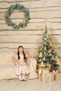 Little girl sitting near Christmas tree Royalty Free Stock Photo