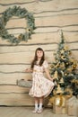 Little girl sitting near Christmas tree Royalty Free Stock Photo