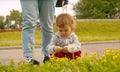 Little girl sitting near flower bed Royalty Free Stock Photo