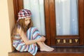 Little girl sitting near window Royalty Free Stock Photo