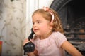 Little girl sitting next to a vintage  telephone Royalty Free Stock Photo