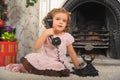 Little girl sitting next to a vintage  telephone Royalty Free Stock Photo