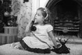 Little girl sitting next to a vintage  telephone Royalty Free Stock Photo