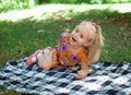 Little girl sitting in the park