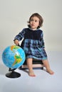 Little girl sitting on a pile of books