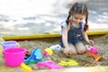 Little girl sitting in the sandbox and playing Royalty Free Stock Photo