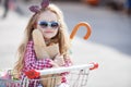 Little girl sitting in shopping trolley Royalty Free Stock Photo