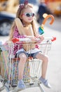 Little girl sitting in shopping trolley Royalty Free Stock Photo