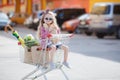 Little girl sitting in shopping trolley Royalty Free Stock Photo