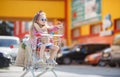 Little girl sitting in shopping trolley Royalty Free Stock Photo