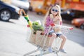 Little girl sitting in shopping trolley Royalty Free Stock Photo