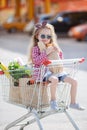 Little girl sitting in shopping trolley Royalty Free Stock Photo