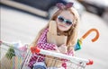Little girl sitting in shopping trolley Royalty Free Stock Photo
