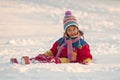 Little girl sitting on the snow Royalty Free Stock Photo