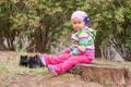 Little girl sitting on a stump. Royalty Free Stock Photo