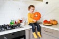 Little girl sitting on the table and playing with halloween inflatable ball Royalty Free Stock Photo