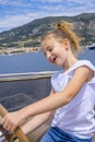 Little girl sitting at the wheel of a yacht. Sea voyage on the boat. Summer trip and vacations. childhood and happiness