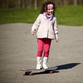 Little girl skating on the street Royalty Free Stock Photo