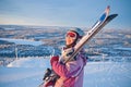 Little girl-skier on the hill watching the sunrise